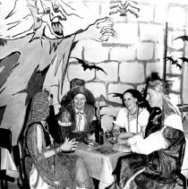 Guests Engaged in Conversation at the Frost Family Halloween Party